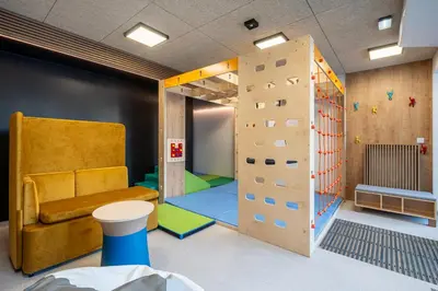 a room with a climbing wall and a rock wall at Lema Tauron Arena Two Bedroom Apartment in Kraków