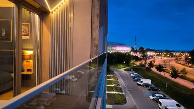 a view of a city street at night from a building at Lema Tauron Arena Two Bedroom Apartment in Kraków