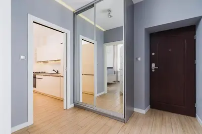a hallway with a mirror and a door in a room at Dajwór 20 - Dzielnica Żydowska in Kraków