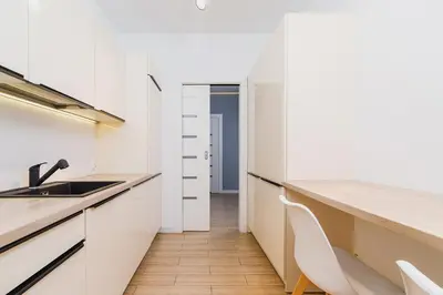 a kitchen with white cabinets and a sink at Dajwór 20 - Dzielnica Żydowska in Kraków