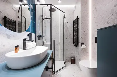 a bathroom with a white sink and a shower at Horizon Apartments Na Dołach - Luxury Apartments near the Vistula River in Kraków