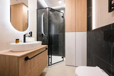 a bathroom with a sink and a shower at Horizon Apartments Na Dołach - Luxury Apartments near the Vistula River in Kraków