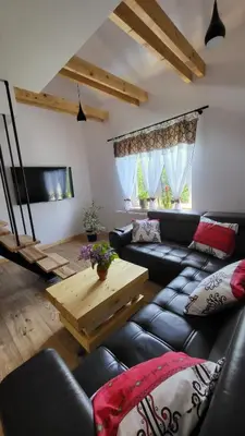 a living room with a couch and a table at Stylove Apartamenty in Kocierz Rychwałdzki