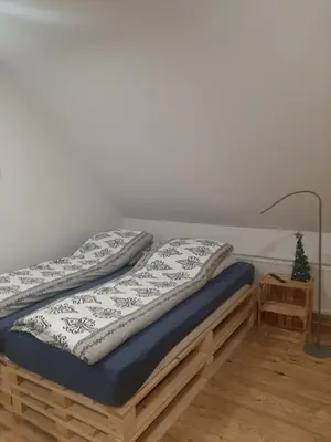 a bed with two pillows on top of it at Stylove Apartamenty in Kocierz Rychwałdzki