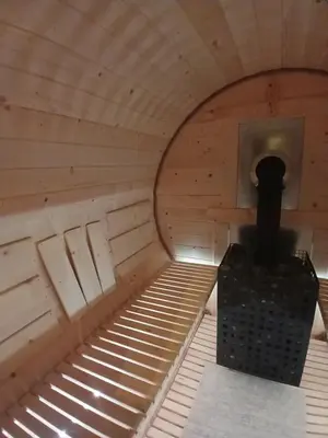 an inside of a sauna with a stove in it at Stylove Apartamenty in Kocierz Rychwałdzki