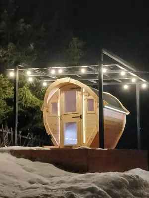 a small wooden boat with lights on it at night at Stylove Apartamenty in Kocierz Rychwałdzki
