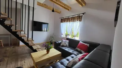 a living room with a couch and a table at Stylove Apartamenty in Kocierz Rychwałdzki