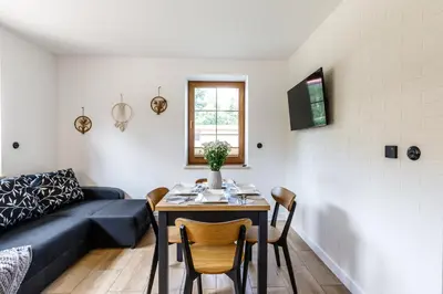 a living room with a table and a couch at Green Door in Oświęcim