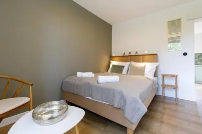 a bedroom with a large bed and a table at Green Door in Oświęcim