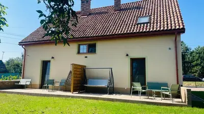 a group of chairs sitting outside of a house at Green Door in Oświęcim