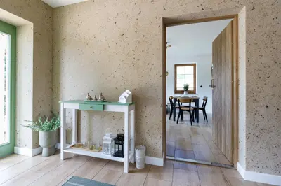 a hallway with a table and a dining room at Green Door in Oświęcim