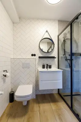 a bathroom with a toilet and a sink and a shower at Green Door in Oświęcim