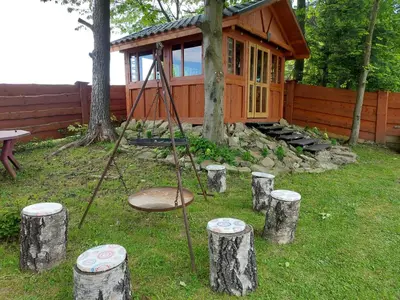 a swing in front of a log cabin at DOMEK NA GRANICY wynajem nocleg in Stankowa