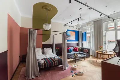 a bedroom with a bed and a couch at Quiet Luxury on Floriańska in Kraków