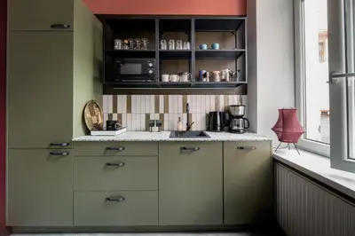 a kitchen with white cabinets and a sink and a window at Quiet Luxury on Floriańska in Kraków