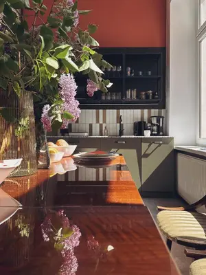 a kitchen with a table with flowers on it at Quiet Luxury on Floriańska in Kraków