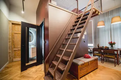 a spiral staircase in a home with a dining room at Quiet Luxury on Floriańska in Kraków