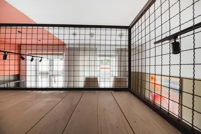 an empty room with a wooden floor in a cage at Quiet Luxury on Floriańska in Kraków