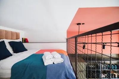 a bedroom with a bed with towels on it at Quiet Luxury on Floriańska in Kraków