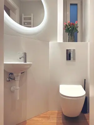 a bathroom with a sink and a toilet and a mirror at Quiet Luxury on Floriańska in Kraków