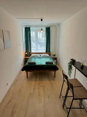 a bedroom with a bed in the middle of a room at Well Apartment in Old Town in Kraków
