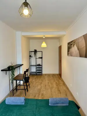 a room with a bed and a table and a desk at Well Apartment in Old Town in Kraków