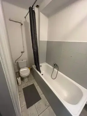 a bathroom with a white tub and a toilet at Well Apartment in Old Town in Kraków