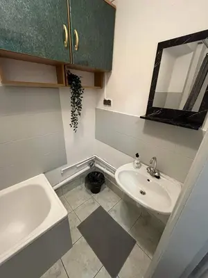 a bathroom with a sink and a mirror and a tub at Well Apartment in Old Town in Kraków