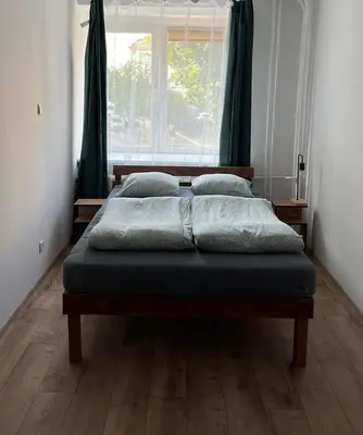 a bed sitting in a room with a window at Well Apartment in Old Town in Kraków