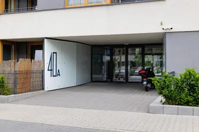an entrance to a building with a scooter parked outside at Eklsuzywny Apartament z Parkingiem w Krakowie by Renters Prestige in Kraków