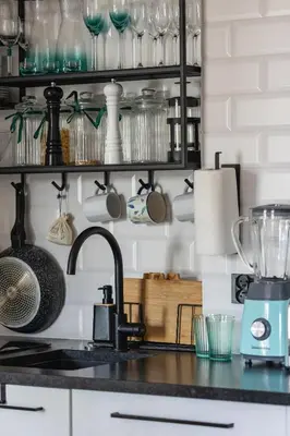 a kitchen counter with a mixer and glasses on a shelf at Kraków Apartament Blisko Centrum Kongresowego i Wawelu by Noclegi Renters in Kraków