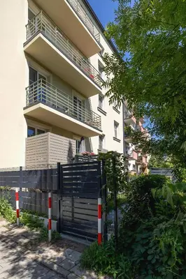 a building with a fence in front of it at Kraków Apartament Blisko Centrum Kongresowego i Wawelu by Noclegi Renters in Kraków