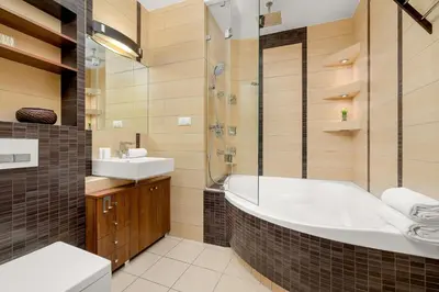 a bathroom with a tub and a sink at Gamers' Paradise - Modern Apartment with Parking in Cracow by Noclegi Renters in Kraków