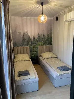 a bedroom with two beds and a window with trees at Kontener 15G in Skawina