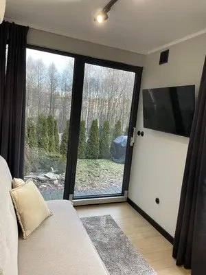 a living room with a large sliding glass door at Kontener 15G in Skawina