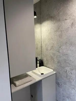 a bathroom with a sink and a mirror at Kontener 15G in Skawina