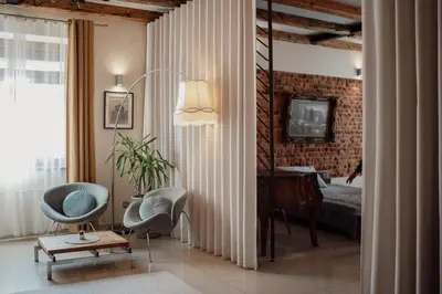 a bedroom with a bed and a desk and a chair at Apartament Deluxe w centrum Brzeska nr 2 in Brzesko