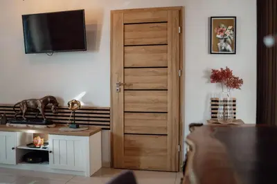 a room with a door with a television on a wall at Apartament Deluxe w centrum Brzeska nr 2 in Brzesko