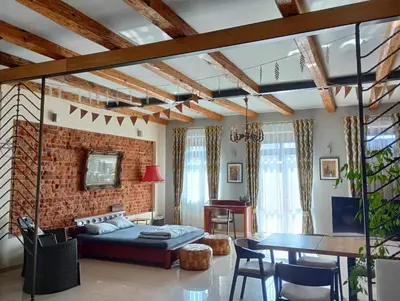 a living room with a couch and a brick wall at Apartament Deluxe w centrum Brzeska nr 2 in Brzesko