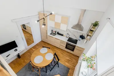 an overhead view of a kitchen and dining room with a table at Old Town Chic Studio with Mezzanine by BookingHost in Kraków