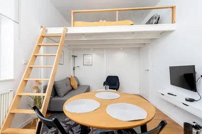 a small room with a table and a bunk bed at Old Town Chic Studio with Mezzanine by BookingHost in Kraków
