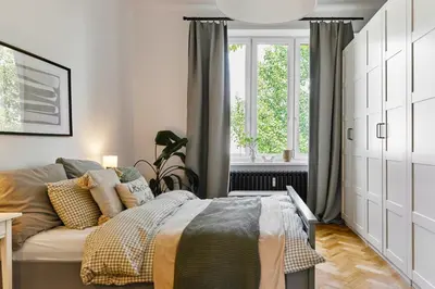 a bedroom with a bed and a large window at Funky Flat Krakow in Kraków