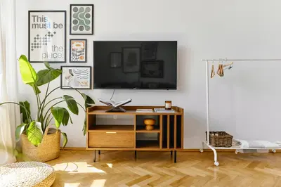 a living room with a tv on a white wall at Funky Flat Krakow in Kraków