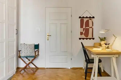 a room with a desk and a chair and a door at Funky Flat Krakow in Kraków