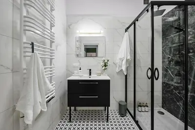 a white bathroom with a sink and a shower at Funky Flat Krakow in Kraków