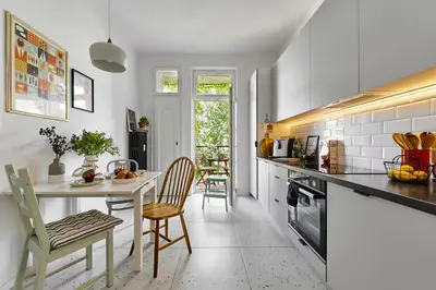 a kitchen with a table and two chairs and a table at Funky Flat Krakow in Kraków