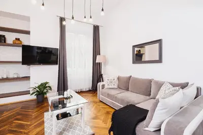 a living room with a couch and a tv at Kazimierz - 34 Dietla street in Kraków