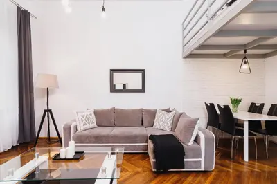 a living room with a couch and a table at Kazimierz - 34 Dietla street in Kraków