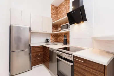 a kitchen with a stainless steel refrigerator and a sink at Kazimierz - 34 Dietla street in Kraków