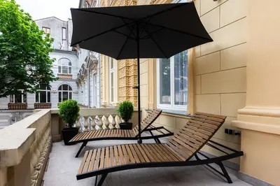 a patio with two benches and an umbrella at Old Town K34 by M Apartments in Kraków